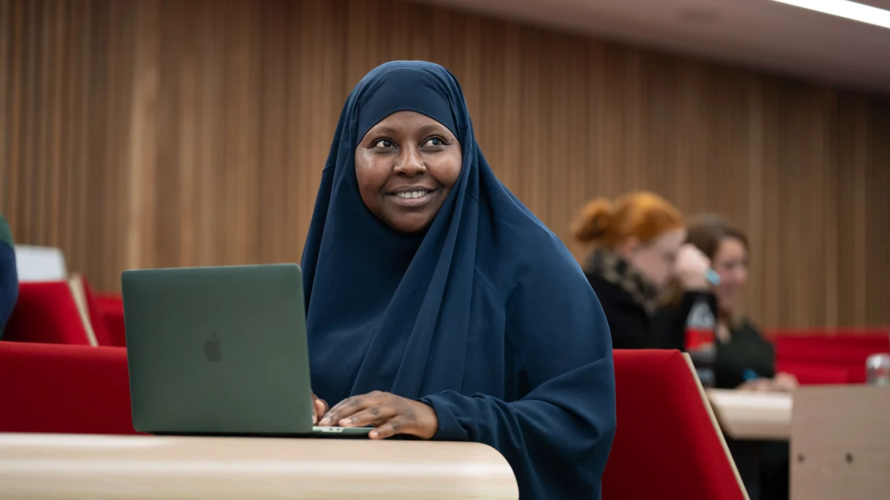 Education, Childhood and Professional Studies in lecture theatre with laptop