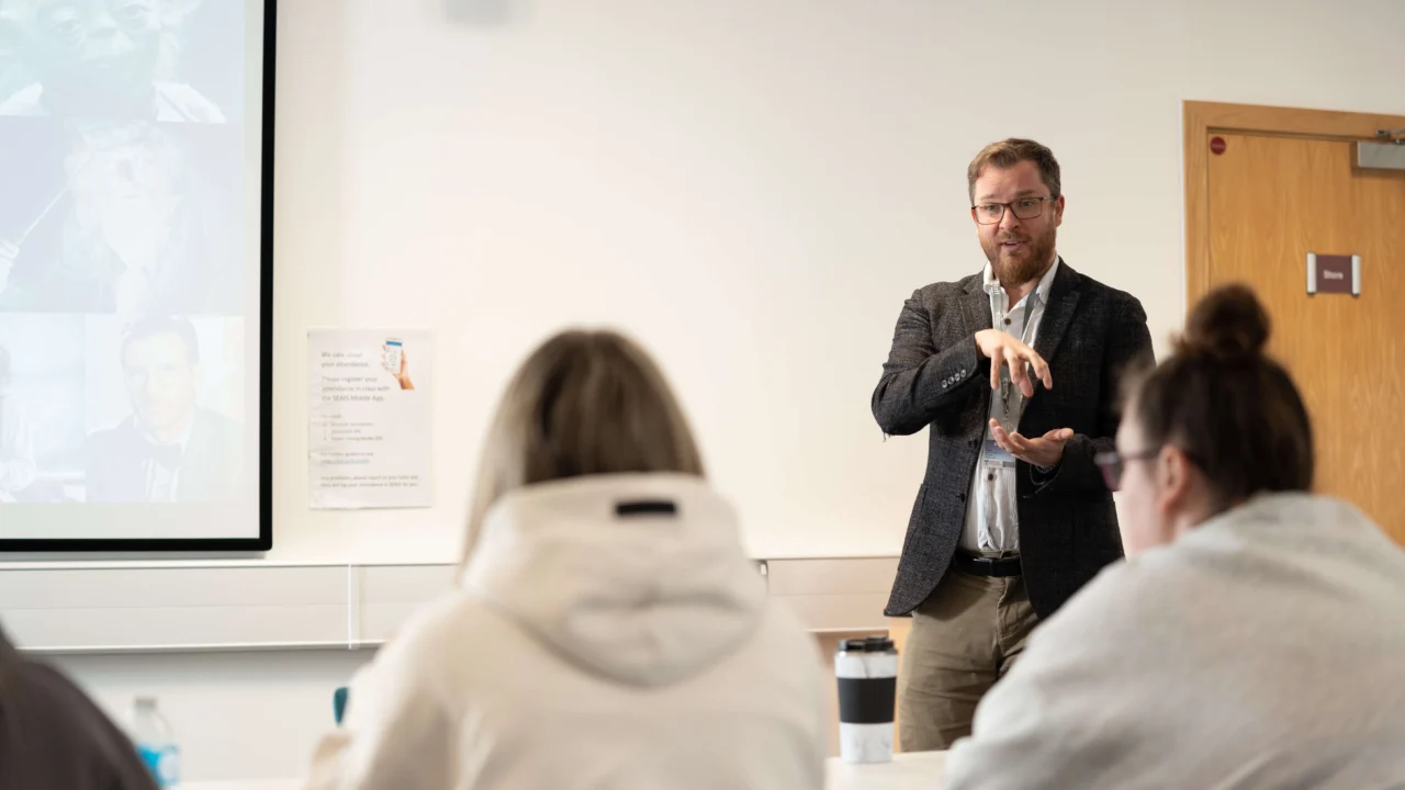 Education, Childhood and Professional Studies students in lecture room with laptop