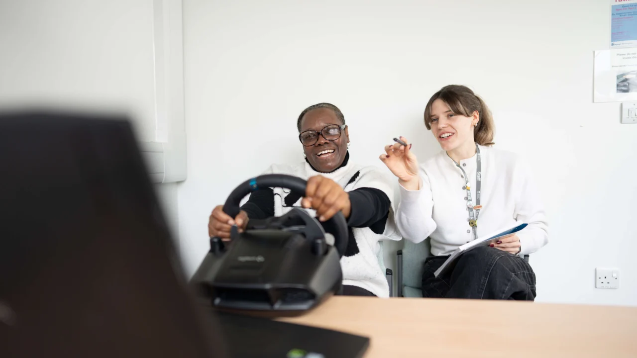 Psychology student and lecturer using driver simulator